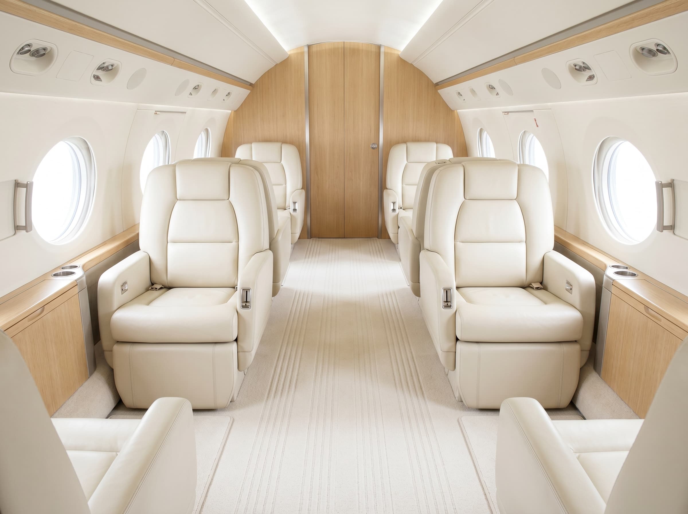 Private jet cabin aisle with freshly extracted wool carpet between cream leather seats